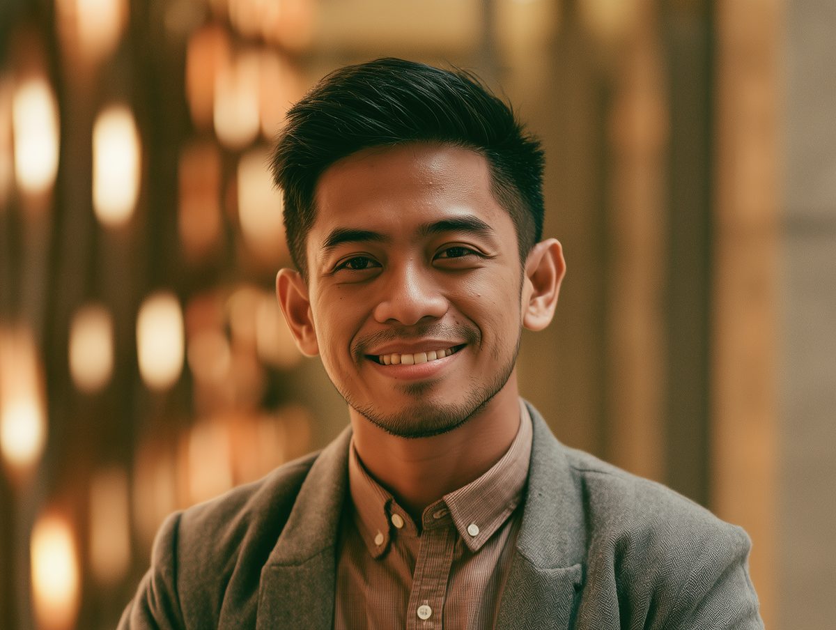 A business owner smiling in a warmly lit interior